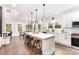 Bright kitchen with white cabinets, large island with seating, and stainless steel appliances at 9527 Walkers Ferry Rd, Charlotte, NC 28214