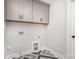 Laundry room featuring cabinets, unique marble tile flooring and washer/dryer hookups at 9527 Walkers Ferry Rd, Charlotte, NC 28214