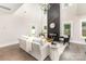 Living room boasts a soaring ceiling, fireplace with black accent wall, and ample natural light at 9527 Walkers Ferry Rd, Charlotte, NC 28214
