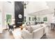 Open-concept living area with fireplace, high ceilings, hardwood floors, and access to the dining area at 9527 Walkers Ferry Rd, Charlotte, NC 28214