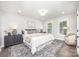 Main bedroom showcasing a bed with decorative pillows, bedside tables, and neutral decor at 9527 Walkers Ferry Rd, Charlotte, NC 28214