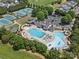 High angle of tennis courts and community swimming facilities surrounded by mature trees at 1007 Wessington Manor Ln, Fort Mill, SC 29715
