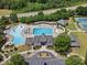 Overhead view of a community pool, clubhouse, and recreation area with lush landscaping at 1007 Wessington Manor Ln, Fort Mill, SC 29715