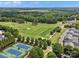 Panoramic aerial view of tennis courts and golf course surrounded by trees and residences at 1007 Wessington Manor Ln, Fort Mill, SC 29715