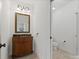 Bathroom featuring custom wood vanity, gold framed mirror and neutral colored tile floors at 1007 Wessington Manor Ln, Fort Mill, SC 29715