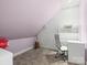 Cozy bedroom featuring sloped ceilings, neutral carpet, and a dedicated desk and workspace area at 1007 Wessington Manor Ln, Fort Mill, SC 29715