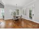 Elegant dining room featuring hardwood floors, natural light, and modern lighting fixture at 1007 Wessington Manor Ln, Fort Mill, SC 29715
