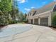 Long driveway leading to a 3-car garage, basketball court, and well-manicured landscaping at 1007 Wessington Manor Ln, Fort Mill, SC 29715