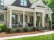Inviting front porch with stone accents, a seating area and neutral paint color at 1007 Wessington Manor Ln, Fort Mill, SC 29715