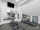 Well-equipped home gym featuring modern exercise equipment and wall-mounted TV at 1007 Wessington Manor Ln, Fort Mill, SC 29715