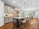 Spacious kitchen featuring an oversized island with seating, pendant lights, and custom cabinetry at 1007 Wessington Manor Ln, Fort Mill, SC 29715