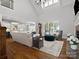 Spacious living room with high ceilings, hardwood floors, a fireplace, and large windows at 1007 Wessington Manor Ln, Fort Mill, SC 29715