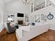 Open concept living room with built-ins and a stone fireplace, and hardwood flooring at 1007 Wessington Manor Ln, Fort Mill, SC 29715