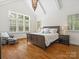 Bright main bedroom featuring vaulted ceiling, large windows, and elegant furnishings at 1007 Wessington Manor Ln, Fort Mill, SC 29715