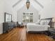 Serene main bedroom with vaulted ceiling, large window, and stylish decor at 1007 Wessington Manor Ln, Fort Mill, SC 29715