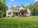 Beautiful home exterior with a large backyard, inviting patio, and well-maintained landscaping at 1007 Wessington Manor Ln, Fort Mill, SC 29715