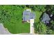 Overhead view of a well-maintained home featuring a manicured lawn, mature trees, and driveway at 101 Creekside Dr, Fort Mill, SC 29715