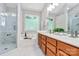 Bright bathroom features double vanity, soaking tub, and a separate glass-enclosed shower at 101 Creekside Dr, Fort Mill, SC 29715