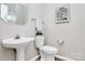 A half bathroom offers pedestal sink, neutral walls, and stylish decor at 101 Creekside Dr, Fort Mill, SC 29715