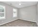 An empty bedroom has plush carpet, light gray walls, and neutral trim and plantation shutters at 101 Creekside Dr, Fort Mill, SC 29715