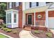 Inviting front entrance with brick facade, black door with wreath, and landscaped garden beds at 101 Creekside Dr, Fort Mill, SC 29715