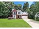 Charming two-story brick home featuring a bay window, manicured lawn, and an attached two-car garage at 101 Creekside Dr, Fort Mill, SC 29715