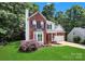 Charming two-story brick home featuring a bay window, manicured lawn, and an attached two-car garage at 101 Creekside Dr, Fort Mill, SC 29715