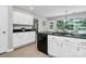A kitchen with white cabinets, black countertops and appliances, and an eat-in breakfast nook at 101 Creekside Dr, Fort Mill, SC 29715