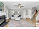Bright living room with hardwood floors, fireplace, white sofa, and staircase at 101 Creekside Dr, Fort Mill, SC 29715
