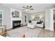 Bright living room with hardwood floors, fireplace, white sofa, and staircase at 101 Creekside Dr, Fort Mill, SC 29715