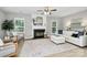 Bright living room with hardwood floors, fireplace, white sofa, and staircase at 101 Creekside Dr, Fort Mill, SC 29715