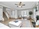Open living room with natural light, fireplace, staircase, neutral colors, and hardwood flooring at 101 Creekside Dr, Fort Mill, SC 29715