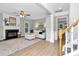 Bright living room with hardwood floors, fireplace, white sofa, and staircase at 101 Creekside Dr, Fort Mill, SC 29715