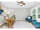 Cozy office space with natural light from shuttered windows, a desk, and comfortable seating at 101 Creekside Dr, Fort Mill, SC 29715