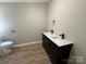 Elegant bathroom with a double sink vanity, modern faucets, and a nearby toilet, blending style and functionality at 1016 Old Thompson Ave, Lancaster, SC 29720