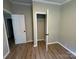 Neutral bedroom featuring wood-look flooring, white trim, and a closet at 1016 Old Thompson Ave, Lancaster, SC 29720