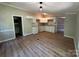 Bright kitchen with white cabinetry, granite countertops, and new flooring, perfect for culinary endeavors and gatherings at 1016 Old Thompson Ave, Lancaster, SC 29720