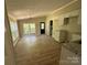 Well-lit kitchen with white cabinets, granite countertops, and new floors with abundant sunlight streaming through the windows at 1016 Old Thompson Ave, Lancaster, SC 29720
