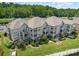 Gorgeous aerial view of condo building with lush greenery and multiple balconies at 104 Pier 33 Dr # 311, Mooresville, NC 28117