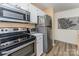 Efficient kitchen layout featuring stainless steel refrigerator, oven, and microwave at 104 Pier 33 Dr # 311, Mooresville, NC 28117