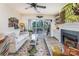 Bright living room featuring a fireplace, ceiling fan, and sliding glass doors leading to a private balcony at 104 Pier 33 Dr # 311, Mooresville, NC 28117