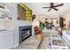 Open-concept living space with a fireplace, a comfortable seating area, and a view into the dining area at 104 Pier 33 Dr # 311, Mooresville, NC 28117