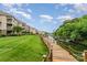 Scenic waterfront view with a wooden boardwalk, grassy area, and boat docks along the lake at 104 Pier 33 Dr # 311, Mooresville, NC 28117