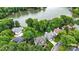 Aerial view showcasing a residential area nestled amongst lush trees, with a lake backdrop, revealing a peaceful and scenic environment at 10452 Quiet Bay Ct, Charlotte, NC 28278