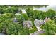 Aerial view of a beautiful neighborhood with mature trees, well-manicured lawns, and stunning lake views in the background at 10452 Quiet Bay Ct, Charlotte, NC 28278