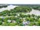 Panoramic aerial shot of a neighborhood surrounded by lush greenery and serene waterfront views, blending nature and community at 10452 Quiet Bay Ct, Charlotte, NC 28278