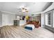 Open basement featuring a bar area, a living space with leather furniture, and large windows at 10452 Quiet Bay Ct, Charlotte, NC 28278