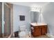 Well-lit bathroom with a glass-enclosed shower, wood vanity, and a large mirror, offering functionality at 10452 Quiet Bay Ct, Charlotte, NC 28278
