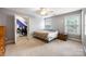 Bedroom featuring a large window, ceiling fan, and neutral-toned walls at 10452 Quiet Bay Ct, Charlotte, NC 28278