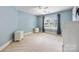 Neutral bedroom with a ceiling fan and natural light from the window at 10452 Quiet Bay Ct, Charlotte, NC 28278